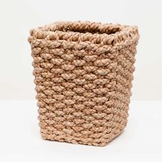 a woven basket is shown on a white surface with the handles down and there are no people around it