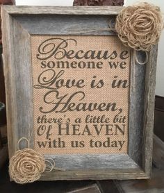 a frame with some flowers on it and the words because someone we love is in heaven