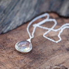 Signature Necklace! Quartz Crystal aka "Protected Being"high vibration crystal wire wrapped necklace in sterling silver. Empowerment through Protection Jewelry: Enhance Your Aura and Confidence Quartz is a Power Protector, healing energy stone. A clear, sparkly, faceted quartz crystal briolette pendant necklace. This clear white crystal is considered a “master healer.” It's said to amplify energy by absorbing, storing, releasing, and regulating it. It's also said to aid concentration and memory. Spiritual Crystal Necklace In Clear Color, Spiritual Silver Drop Crystal Necklaces, Spiritual Silver Necklace With Natural Inclusions, Clear Crystal Spiritual Necklace, Spiritual Silver Teardrop Crystal Necklace, Silver Faceted Crystal Necklaces For Healing, Silver Faceted Crystal Necklace For Healing, Silver Spiritual Crystal Necklace With Large Stone, Spiritual Silver Drop Necklace