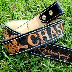 two black and brown leather straps with the words chase runaway on them sitting in grass