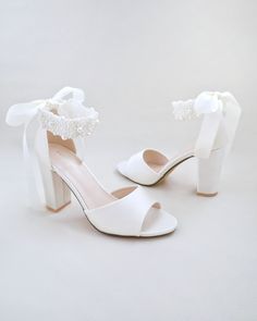 Satin block heel wedding sandals adorned with all over pearls ribbon strap . Elegance and feminine inspired wear for your special day. The delicate pearl beads are placed to create a graceful classic style. Simple and easy wear for bridal wear, bridesmaids, holiday party, wedding parties, and any special occasions. The light blue color can easily be your something blue.DETAILS:HEELS: 3.75 inchesCOLORS AVAILABLE: Ivory, White and Light BlueUPPER: Synthetic upper and liningMATERIALS: Manmade outso Shoes For Brides, Bridal Flats, Shoes Heels Classy, Satin Shoes, Simple Shoes, Bridal Sandals, Wedding Guest Shoes, Heels Classy, Wedding Sandals