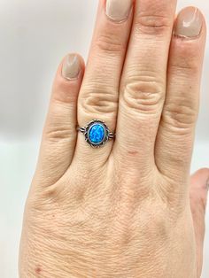 "Welcome to Darling Grace! This ring is a gorgeous blue opal ring. The blue color on this ring is so mesmerizing.  Size: 7 Metal Purity: 925 Sterling Silver Stone: Blue Opal Free Shipping!  Comes packaged in a ring box ready to gift! Consider upgrading your box to black leather and purchasing a cleaning cloth during check out.  You can take a peek of these options in the \"Essentials\" section.  Thank you!" Blue Opal Promise Ring, Blue Sterling Silver Opal Promise Ring, Blue Opal Open Ring In Sterling Silver, Blue Opal Round Ring, Blue Round Opal Ring, Blue Opal Gemstone Ring As Gift, Blue Opal Open Ring With Gemstone, Blue Opal Birthstone Ring In Sterling Silver, Blue Opal Gemstone Ring Gift