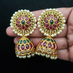 "These Jhumka Earrings set has an excellent finish and gives out an exquisite sense of style. If you are looking for an amazing Fashion Jewelry set for special occasions such as Anniversary, Engagement, Party, Wedding or for gifting, then your search ends here. Handmade Indian Temple Jewelry, best to wear it for traditional ceremonies or Indian wedding. This bridal jewelry has an ethnic finish. It has Cubic Zircon stones with ruby and emeralds. It is a Bollywood style one gram jewelry. There are Fusion Style Peacock Design Earrings For Wedding, Fusion Style Wedding Earrings With Peacock Design, Fusion Wedding Earrings With Peacock Design, Temple Jewelry Style Jhumkas With Peacock Design, Temple Jewelry Style Peacock Design Jhumkas, Temple Jewelry Peacock Design Jhumkas, Temple Jewelry Peacock Jhumkas, Elegant Multicolor Peacock Design Jhumkas, Elegant Round Jhumkas With Peacock Design