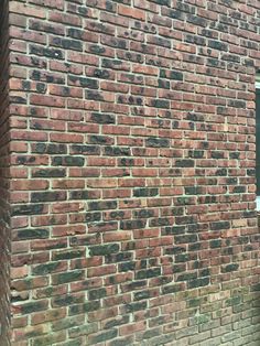 a brick building with a clock on the side