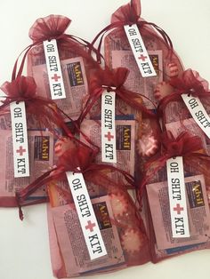 six bags of candy wrapped in red organ ribbon and labeled with the names of different states