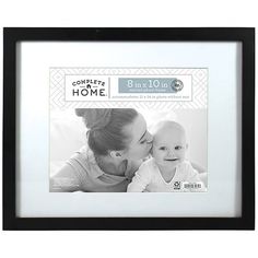 a black and white photo frame with a baby kissing it's mother