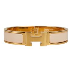 This Clic Clac H bracelet is in Beige Nacre enamel with gold plated hardware. Origin: France Condition: Pristine; new or never worn (plastic on hardware) Accompanied by: Hermes box, Hermes dustbag, carebook Measurements: Diameter: 2.25"; Circumference: 7"; Width: .5" Hermes Clic H Bracelet, Gifts Wishlist, Unrealistic Wishlist, Beige Jewelry, H Bracelet, Hermes Bracelet, Hermes Jewelry, Hermes Box, Enamel Bracelet