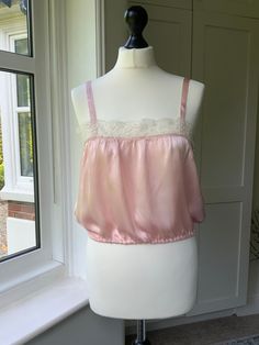 Gorgeous 1930s 1940 handmade glossy pink rayon satin camisole, sleeveless top, boudoir top.  Perfect for a bride. Ivory lace deep trim. Slim satin straps. Side opening with mother of pearl buttons and handstitched  button loops. Excellent unworn condition.   Stored since new. Measurements taken flat: Armpit to armpit.    34 " Waist ( unstretched).  28 "    Fully stretched :  33 inches Length from top of straps.  18" Laundered and ready to wear. Glossier Pink, Satin Camisole, Bridal Lingerie, Lace Crop Tops, Mother Of Pearl Buttons, Ivory Lace, Favorite Outfit, Sleeveless Top, Ready To Wear