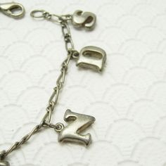 Vintage charm bracelet in silver tone with lobster clasp on a figaro chain bracelet. Slightly puffy two sided letter charms spell the word friends. A sweet vintage bracelet and mom would love from her daughter. Unsigned, in very good condition, 7 1/8 inch long. Find lots more vintage jewelry at Purple Daisy Jewelry! http://www.etsy.com/shop/purpledaisyjewelry Thanks a bunch for shopping for vintage jewelry at Purple Daisy Jewelry on Etsy! Vintage Personalized Dangle Jewelry, Personalized Vintage Dangle Jewelry, Silver Nickel-free Name Bracelet For Friendship, Vintage Adjustable Charm Bracelet For Everyday, Metal Charm Bracelet For Birthday And Mother's Day, Antique Silver Nickel-free Charm Bracelet For Gift, Metal Charm Bracelets For Birthday, Antique Silver Charm Bracelet As Gift, Antique Silver Metal Charm Bracelet Gift