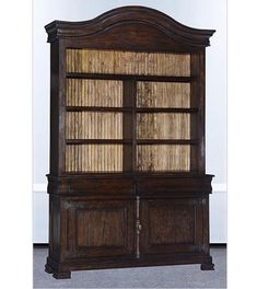 an old wooden bookcase with wicker doors