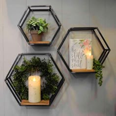 three hexagonal wall shelves with candles and greenery