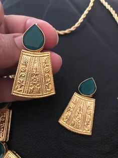 Gold plated and handcrafted with semi precious emerald stones necklace set Perfect for wedding and parties Pre order. Traditional Metal Jewelry With Stone Setting, Handmade Kundan Metal Necklace In Elegant Style, Handmade Elegant Kundan Metal Necklace, Elegant Handmade Kundan Metal Necklace, Handmade Chandbali Jewelry For Formal Occasions, Handmade Chandbali Jewelry For Formal Events, Green Gold Plated Bollywood Necklace, Handmade Elegant Metal Kundan Necklace, Traditional Brass Necklace For Party