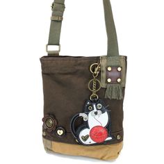 Fat Cat Patch Crossbody Bag in Dark Brown by Chala Brand new with tag. Size 10w in x 4d in x 10.5H inches Strap adjustable: 13-26 inches Super cute & casual this  purse includes the Fat Cat Key Fob/coin purse. The Crossbody style is so practical too. Accented with fabricated flower & fun wood buttons. The Top Zip closure makes it easy to get into. Love  the antique brass toned hardware and fully lined interior. One interior zippered pocket Two interior slide pockets Detachable  Key Fob / coin pu Cat Design Crossbody Travel Bag, Everyday Use Crossbody Shoulder Bag With Cat Design, Cat Design Crossbody Shoulder Bag For Everyday Use, Everyday Crossbody Shoulder Bag With Cat Design, Cat Design Pouch Shoulder Bag For Travel, Travel Pouch Shoulder Bag With Cat Design, Travel Shoulder Bag With Cat Design, Cat Design Shoulder Satchel, Cat Design Satchel Bag For Everyday Use