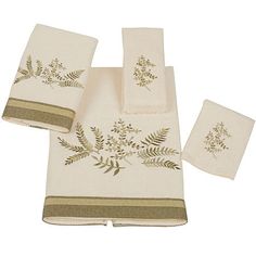 four piece towel set in white and gold with green leaves on the front, along with two matching hand towels