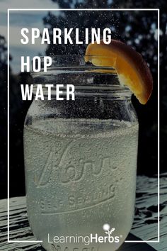 a jar filled with water sitting on top of a wooden table