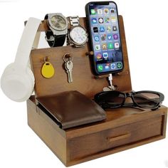 an iphone, watch, and other items in a wooden box