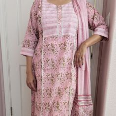 This floral printed straight kurta set is a delightful fusion of elegance and charm, featuring vibrant floral patterns that add a touch of whimsy to the ensemble. It comes with a pair of straight pants. The kurta has a round neckline, three-quarter sleeves, side slits, and a curved hemline, while the pants have an elasticated waistband. With its flattering silhouette and coordinated design, this kurta set offers a versatile and stylish option for various occasions. This beautiful soft 100% cotto Floral Print Traditional Wear For Spring Festivals, Floral Print Traditional Wear For Festive Spring, Floral Traditional Wear For Festive Spring Season, Pink Bohemian Palazzo Set With Printed Motifs, Pink Floral Print Palazzo Set For Navratri, Floral Print Straight Kurta For Eid, Traditional Pink Floral Print Kurta, Pink Floral Print Straight Kurta Traditional Wear, Long Sleeve Kurta With Floral Print For Diwali