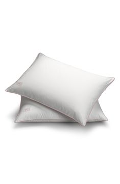 two white pillows sitting next to each other