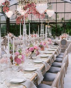 a long table is set with flowers and candles