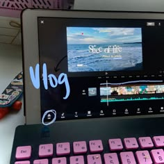 an open laptop computer sitting on top of a white desk next to a pink keyboard