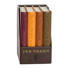 four books in a book holder with the words j r r tolken on them