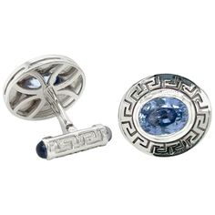 Elevate your formal attire to new heights with these exquisite 18k White Gold Cufflinks, featuring a breathtaking total of 6.83 carats of Oval Cornflower Blue Sapphires on the front and Cabochon Iolites adorning the swivel backings. These cufflinks are a true masterpiece, meticulously crafted to harmonize the allure of precious gemstones with the timeless elegance of Greek key detailing, resulting in an opulent and distinguished accessory. Captivating Cornflower Blue Sapphires: The front of each Luxury Formal Cufflinks, Luxury Cufflinks For Formal Occasions, Luxury Sapphire Jewelry For Formal Occasions, Elegant Yellow Gold Oval Cufflinks, Luxury Diamond Cufflinks, Luxury Sapphire Formal Jewelry, Luxury Polished Finish Cufflinks For Formal Occasions, Luxury Polished Cufflinks For Formal Occasions, Luxury Formal Sapphire Jewelry