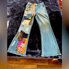 a pair of jeans with patches and buttons on them