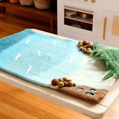 a wooden table with a towel on top of it and some balls in the middle