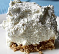 a close up of a piece of cake on a plate with cream cheese frosting