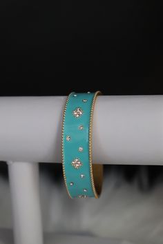 The Turquoise Cuff Bracelet boasts a captivating design with vibrant turquoise stones intricately embedded in a sleek cuff. This accessory effortlessly combines a pop of color with a chic and versatile style, making it a statement piece for any fashion ensemble. Size: 6 3/4 inches - Inner Diameter Closure: Bangle Hinge Bracelet Material: Brass with 18K Gold Plating with Rhodium Coating Lead Free and Hypoallergenic Trendy Turquoise Bracelets For Party, Turquoise Metal Bangle Cuff Bracelet, Turquoise Metal Bangle Jewelry, Trendy Turquoise Metal Bracelets, Trendy Turquoise Bangle Jewelry, Elegant Turquoise Bracelet For Party, Turquoise Bracelet Jewelry, Turquoise Bangle Bracelets For Party, Turquoise Bangle Bracelet For Party