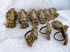 antique brass drawer pulls and knobs on a white lace tablecloth