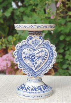 a blue and white vase sitting on top of a table