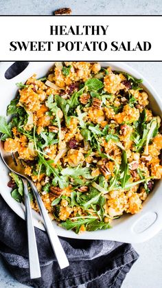 healthy sweet potato salad in a white bowl with spoons and fork on the side