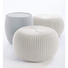 three white knitted stools sitting next to each other