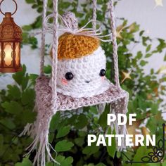 a crocheted doll hanging from a string with a lantern in the background and text overlay that reads, free pattern