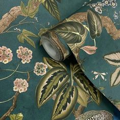 a wallpaper with birds and flowers on it, next to a blue background that has green leaves