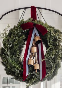 a christmas wreath with bells hanging from it