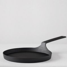 a black frying pan sitting on top of a white table