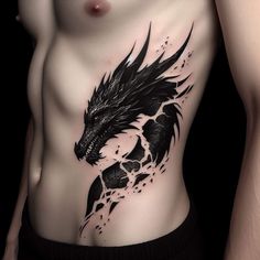 a man's chest with a dragon tattoo on the side and black paint splatters all over it