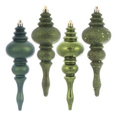 four green glass ornaments are lined up in a row