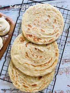 several flat breads are stacked on a cooling rack