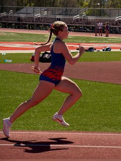 a woman running on a track during a race