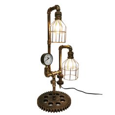 an old fashioned steam engine table lamp with two light bulbs on the base and a clock