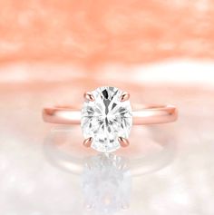 Gorgeous solitaire white sapphire ring made of 14k rose gold over 925 solid sterling silver, making a simple but elegant statement piece. Center Stone: Sapphire Stone Creation: 100% genuine lab-grown Color: White/ Colorless Shape: Oval Gem size: 7.0 x 9.0 mm Carat Weight: 2 ct. (approx.) Hardness: 9-9.5 (Mohs scale) ►Average band width: 2mm ►Note: this ring has a high profile and fits with most wedding bands or stacking rings. ►Please be aware that plated jewelry can wear off over time, if this Blue Gemstone Engagement Rings, Dainty Promise Ring, Sapphire Promise Rings, Solitaire Diamond Engagement Ring, White Sapphire Engagement Ring, Oval Diamond Ring, September Birthstone Jewelry, Mohs Scale, Solitaire Rings