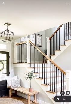 a living room filled with furniture and a stair case