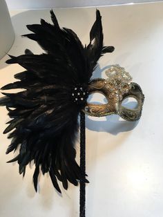 Black Feather mask- Masked ball- New Years Eve- Save Venice -Masquerade Ball- Mardi Gras Mask -Halloween Masked Ball Hello, Perfect for a masquerade party- birthday celebration, or New years eve celebration. This black coque feather rhinestone / sequin gold mask is made with tie. The feathers are about 8 inches. Can be made in: Gold and black mask Solid black mask Silver and black mask Cardboard molded over plastic mask/ makes it durable and then its painted. Custom colors available. Can be made Gothic Masks For Halloween And Masquerade, Halloween Masquerade Full Face Costume Accessories, Full Face Halloween Masquerade Costume Accessory, Venetian Full Face Mask For Halloween, Venetian Full Face Halloween Mask, Fantasy Eye Mask For Costume Masquerade, Full Face Theater Masks For Halloween, Full Face Masquerade Costume For Halloween, Fantasy Eye Mask For Masquerade Costume