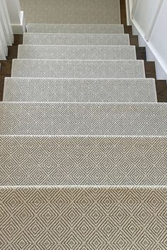 carpeted stairs leading up to the first floor