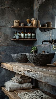 two black bowls are sitting on a wooden shelf in front of a mirror and shelves