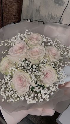 a bouquet of pink roses and baby's breath