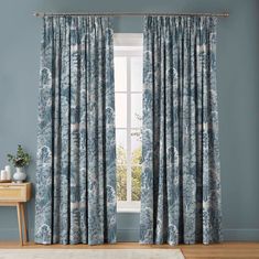 a blue and white curtain hanging in front of a window